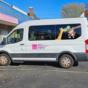 Van wrapped with cartoon-style vehicle graphics