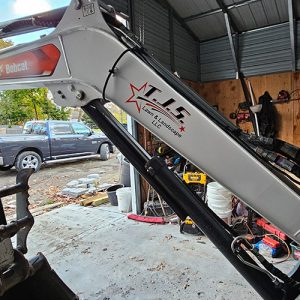 Excavator arm featuring custom landscaping company graphics