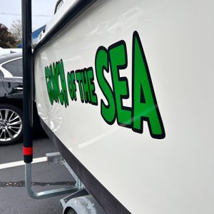 Boat with custom marine vinyl graphics on hull