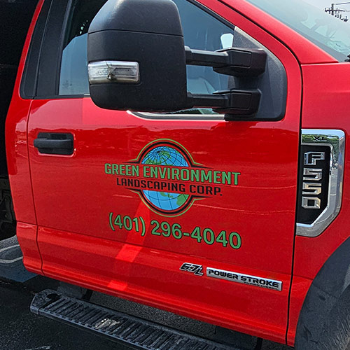Red landscaping truck with custom vehicle graphics