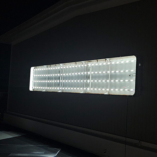 Led Retrofit 4 LED retrofitted cabinet sign glowing brightly at night