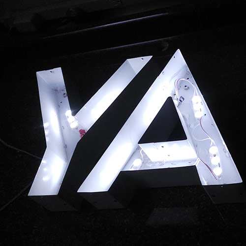 Illuminated channel letters with retrofit LED lighting system